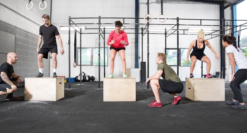 Crossfit group trains box jump